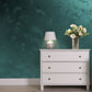 Silver Sand decorative paint in Bottle Green 40 shade with a wind-blown sand textured pearlescent finish on a wall