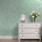 Silver Sand decorative paint in Bottle Green 2 shade with a wind-blown sand textured pearlescent finish on a wall